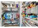 Efficiently arranged closet space with organized shelving, wire baskets, and ample storage for clothes and toys at 15592 E Kenyon Ave, Aurora, CO 80013