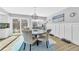 Elegant dining room featuring a round table, stylish chairs, and sliding doors to the outside at 15592 E Kenyon Ave, Aurora, CO 80013