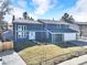 Charming two-story home with a well-manicured lawn, and a classic, inviting facade with an attached garage at 15592 E Kenyon Ave, Aurora, CO 80013