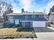 Charming two-story home with a well-manicured lawn, a two-car garage, and a classic, inviting facade at 15592 E Kenyon Ave, Aurora, CO 80013