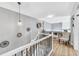 Upstairs hallway landing with stylish decor, built-in shelves, and a comfortable chair at 15592 E Kenyon Ave, Aurora, CO 80013