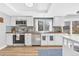 Bright kitchen with stainless steel appliances, tile backsplash, and wooden countertops at 15592 E Kenyon Ave, Aurora, CO 80013