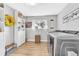 Clean laundry room with modern machines, storage, and natural light at 15592 E Kenyon Ave, Aurora, CO 80013