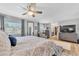 Spacious main bedroom featuring an ensuite, ceiling fan, and a large window with lovely exterior views at 15592 E Kenyon Ave, Aurora, CO 80013