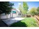 Charming backyard featuring a spacious stone patio and lush green lawn at 15577 Greenstone Cir, Parker, CO 80134