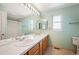 Bathroom featuring dual sinks and a large mirror with a bright vanity at 15577 Greenstone Cir, Parker, CO 80134