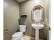 Charming powder room with pedestal sink, decorative mirror, and neutral tones at 15577 Greenstone Cir, Parker, CO 80134
