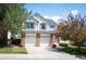 Charming two-story home featuring a three car garage, brick accents, and well-maintained landscaping at 15577 Greenstone Cir, Parker, CO 80134