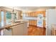 Well-lit kitchen with granite countertops, white appliances, a bay window and wood flooring at 15577 Greenstone Cir, Parker, CO 80134