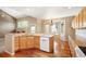 Spacious kitchen with island, wood floors, stainless steel dishwasher and ample cabinetry at 15577 Greenstone Cir, Parker, CO 80134