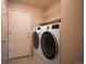 Functional laundry room equipped with washer, dryer, and storage shelving at 15577 Greenstone Cir, Parker, CO 80134