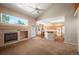 Open-concept living room with fireplace, hardwood floors and a large window with natural light at 15577 Greenstone Cir, Parker, CO 80134