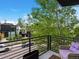 Balcony view of modern buildings, greenery, and a tree-lined street with parked cars at 1880 W 32Nd Ave, Denver, CO 80211