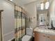 Full bathroom featuring a shower and tub combo with a shower curtain and vanity with ample storage at 1880 W 32Nd Ave, Denver, CO 80211
