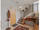 Inviting foyer with tile flooring, staircase, coat rack, and tasteful decor, providing a warm welcome at 1880 W 32Nd Ave, Denver, CO 80211
