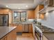 Bright kitchen with stainless steel appliances, modern cabinetry, and a view of the neighborhood at 1880 W 32Nd Ave, Denver, CO 80211