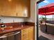 Modern kitchenette with granite counters and cabinetry leading to rooftop patio at 1880 W 32Nd Ave, Denver, CO 80211