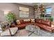 Cozy living room featuring hardwood floors, an artistic painting, and abundant seating at 1880 W 32Nd Ave, Denver, CO 80211