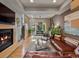 Open-concept living room featuring hardwood floors, a fireplace, and abundant natural light at 1880 W 32Nd Ave, Denver, CO 80211