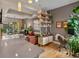 Inviting living space with hardwood floors, leather sofa, open shelving, and adjacent home office area at 1880 W 32Nd Ave, Denver, CO 80211