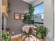 Cozy home office featuring a comfortable desk, chair, indoor plants, and natural light from a large window at 1880 W 32Nd Ave, Denver, CO 80211