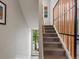 A staircase with wooden railings and a window with a view of lush green trees at 1880 W 32Nd Ave, Denver, CO 80211