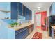 Bright kitchen with blue cabinetry, stainless steel appliances, and colorful decor at 3131 E Alameda Ave # 2102, Denver, CO 80209