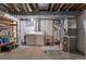 Unfinished basement featuring washer, dryer, utility sink, furnace and storage shelves at 12931 W 20Th Ave, Golden, CO 80401