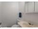 Bright bathroom featuring a sink, vanity, toilet, towel rack and a mirror cabinet at 12931 W 20Th Ave, Golden, CO 80401