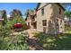 Charming backyard with a stone path, well-manicured garden beds, and brick home at 3764 Newton St, Denver, CO 80211