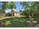 Private backyard features mature trees, a storage shed, and ample space for gardening and recreation at 3764 Newton St, Denver, CO 80211