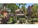 Charming brick home with lush landscaping, mature trees and a wrought iron fence at 3764 Newton St, Denver, CO 80211