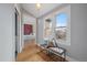 Hallway with wood floors, a cozy bench, and plenty of natural light overlooking the bedroom at 3764 Newton St, Denver, CO 80211