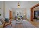 Bright living room with wood floors, a modern sofa and chair, and natural light from a window at 3764 Newton St, Denver, CO 80211
