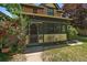 Close up shot of an inviting sunroom featuring yellow and green paint with an exterior door at 3764 Newton St, Denver, CO 80211