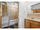 Cozy bathroom featuring a tiled shower with glass door and wooden vanity at 2400 N Broadway # 4, Denver, CO 80205