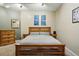 Bedroom with wooden bed, grey linens, and decorative artwork at 2400 N Broadway # 4, Denver, CO 80205