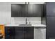The kitchen boasts black cabinets, subway tile backsplash, stainless steel dishwasher at 2400 N Broadway # 4, Denver, CO 80205