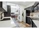 Open concept kitchen with stainless appliances, bar seating, and views to the living area at 2400 N Broadway # 4, Denver, CO 80205
