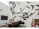 Open-concept living room highlighting a dramatic mural wall and comfortable seating arrangement at 2400 N Broadway # 4, Denver, CO 80205