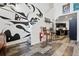 Bright living space with artistic mural, modern floors, and seamless flow into the kitchen area at 2400 N Broadway # 4, Denver, CO 80205