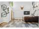 Spacious living room featuring a leather sofa, high ceilings, and decorative wall art at 2400 N Broadway # 4, Denver, CO 80205