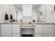 Elegant bathroom featuring dual sinks with granite countertops and a shared vanity area at 5779 Piney River Pl, Brighton, CO 80601