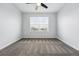 Bright bedroom featuring neutral carpet, a ceiling fan, and a window with blinds at 5779 Piney River Pl, Brighton, CO 80601