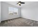 Well-lit bedroom with neutral carpet, a ceiling fan, and a window providing natural light at 5779 Piney River Pl, Brighton, CO 80601