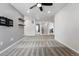 A spacious carpeted room with overhead lighting and a view leading to the other rooms at 5779 Piney River Pl, Brighton, CO 80601