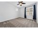 This bedroom features soft carpet, neutral paint, a ceiling fan, and a window with lots of light at 5779 Piney River Pl, Brighton, CO 80601