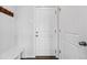Inviting entryway featuring coat rack and bench seating near a well-lit door at 5779 Piney River Pl, Brighton, CO 80601