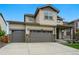 Two-story home showcasing a three-car garage and inviting curb appeal at 5779 Piney River Pl, Brighton, CO 80601