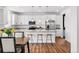 Bright kitchen features stainless steel appliances, a large island, and bar seating at 5779 Piney River Pl, Brighton, CO 80601